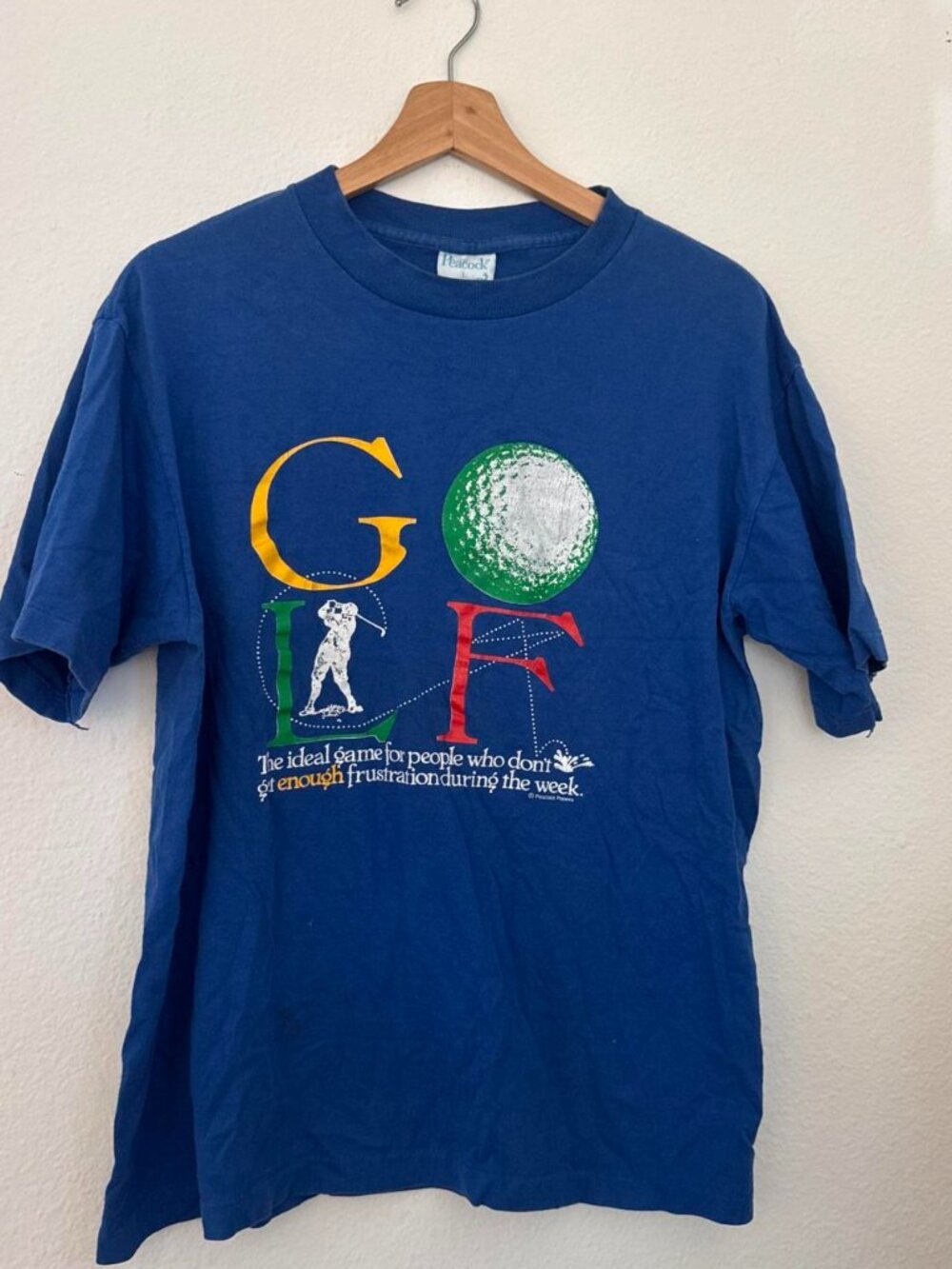 Vintage 90s Peacock Golf Tee with graphic of a golfer and golf ball with the